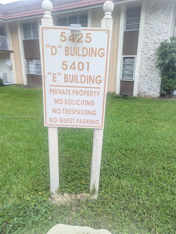 Partial view of a multi-story building with a sign indicating private property and building numbers.