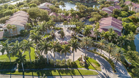 Aerial view of a gated residential community with multiple buildings and trees.