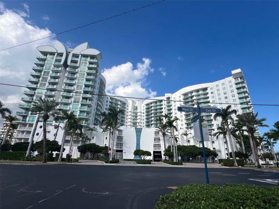 Front view of a multi-story residential building with modern architectural design.
