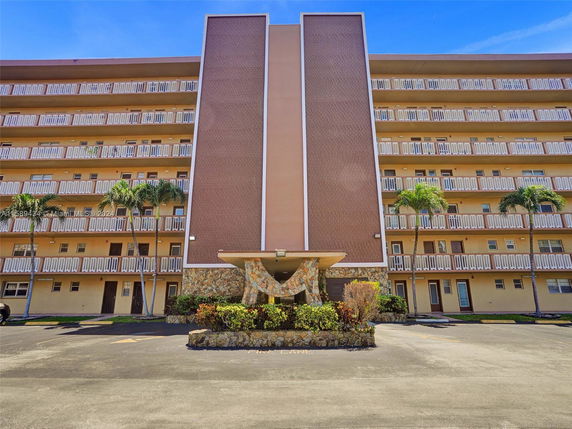 Front view of a multi-story residential building with balconies.