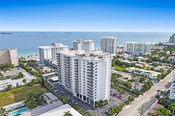 Aerial view of high-rise buildings near the coastline with the ocean in the background.
