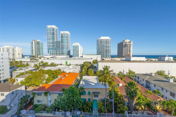 View of cityscape with multiple residential buildings and high-rise towers in the background.