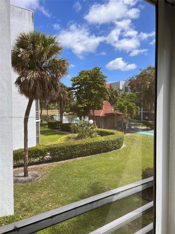 View from a building capturing the surrounding green landscape and trees.
