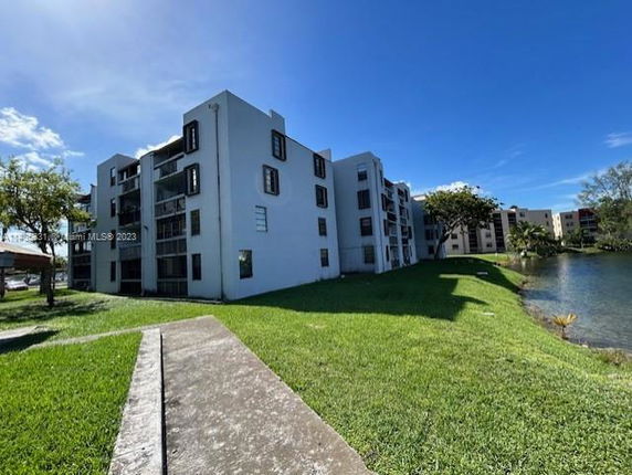Front view of a multi-story apartment building with balconies.