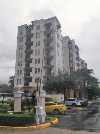 Front view of a multi-story residential building with balconies.