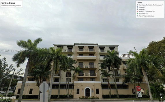 Front view of a multi-story apartment building with balconies.