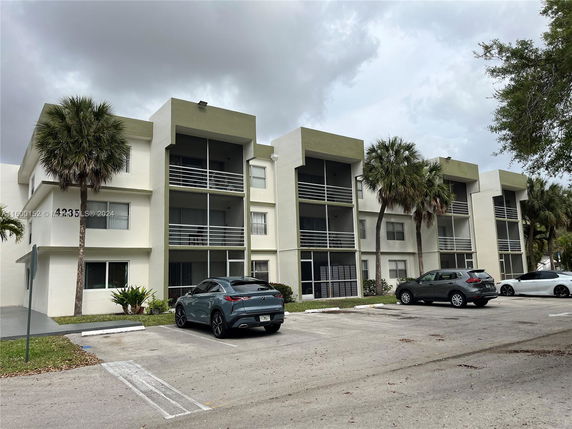 Front view of a multi-story apartment building with balconies.