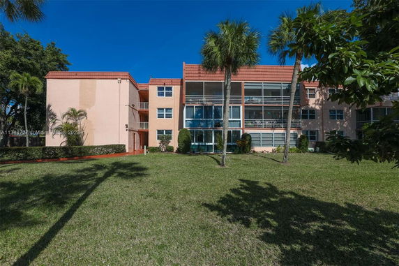 Front view of a multi-story apartment building with balconies.