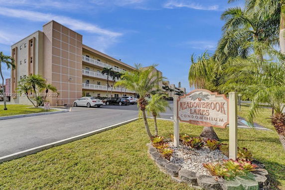Front view of a multi-story condominium building with visible balconies.