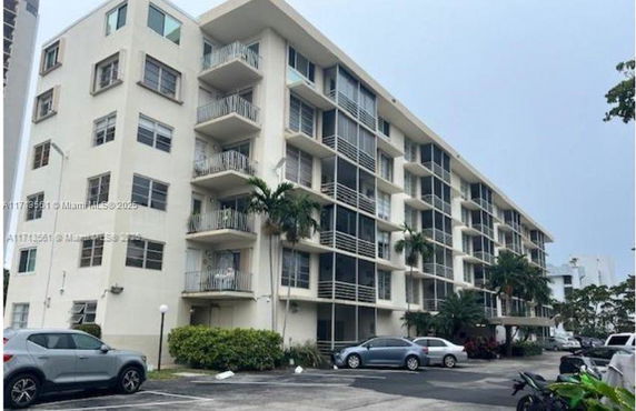 Front view of a mid-rise residential building with balconies.