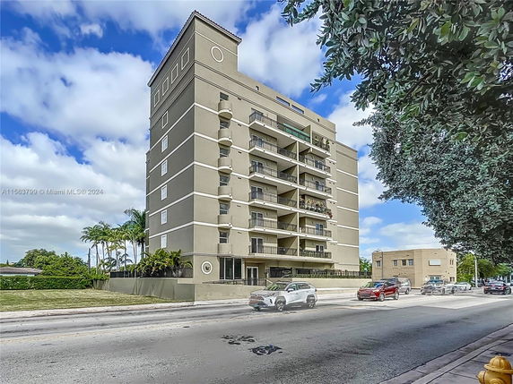 Front view of a multi-story residential building with balconies.