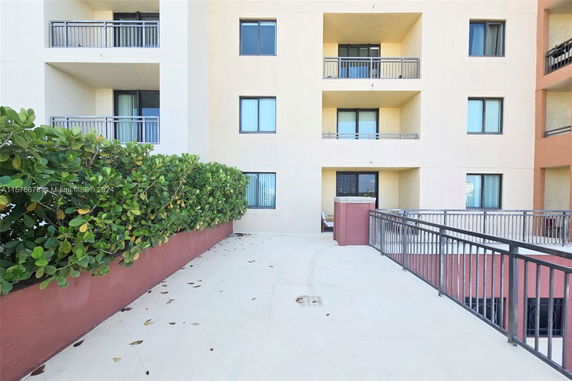 Exterior view of a multi-story building with balconies and windows.