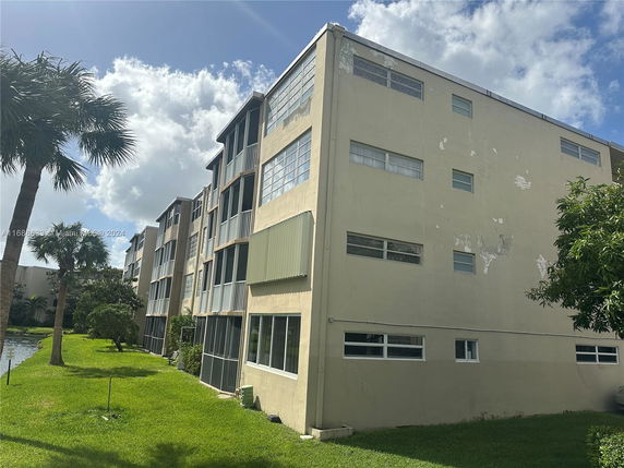 Side view of a multi-story residential building with balconies.