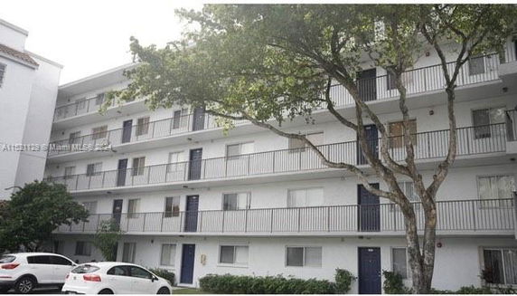 Front view of a multi-story residential building with balconies.