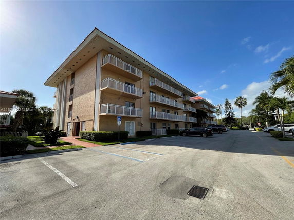 Front view of a multi-story residential building with balconies.