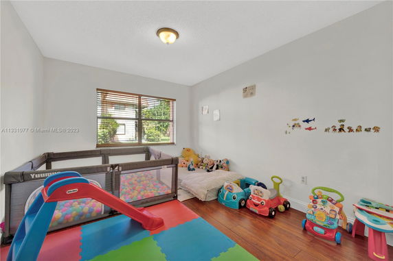 Indoor playroom with toys and a small slide.
