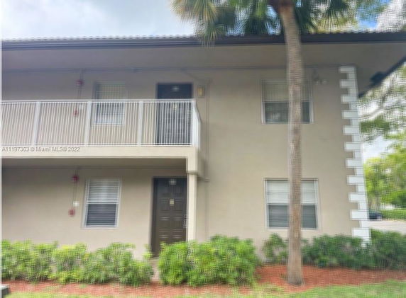 Front view of a two-story building with balconies.