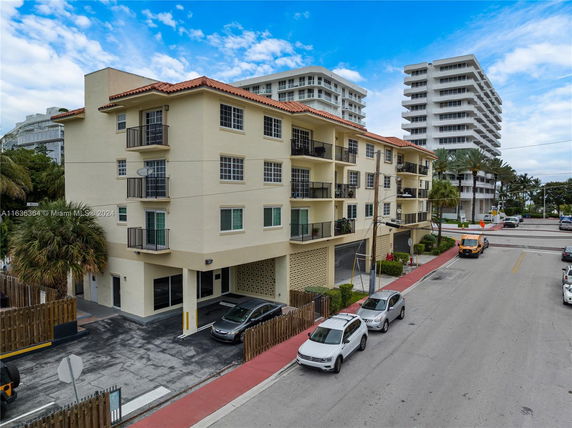 Front view of a multi-story residential building with balconies.