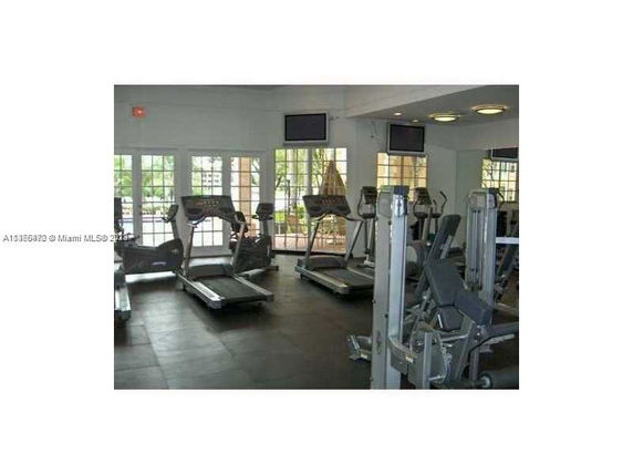Indoor gym area with exercise equipment such as treadmills and weight machines.