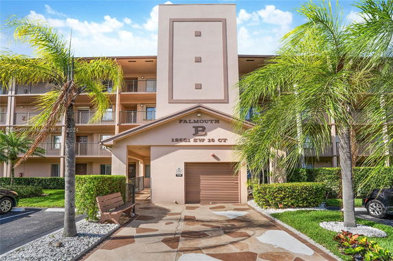 Front view of a multi-story residential building with balconies.