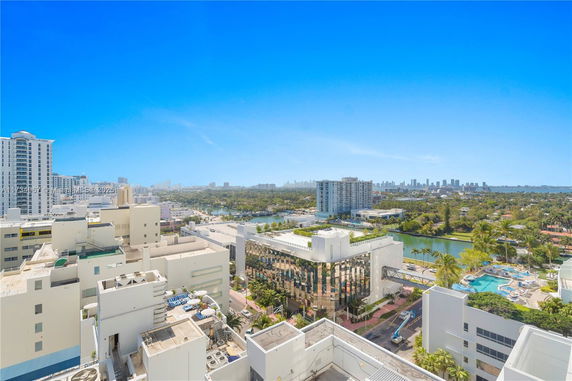 Panoramic view of buildings and city skyline with a clear blue sky.