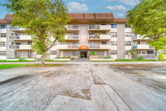 Front view of a multi-story residential building with balconies.
