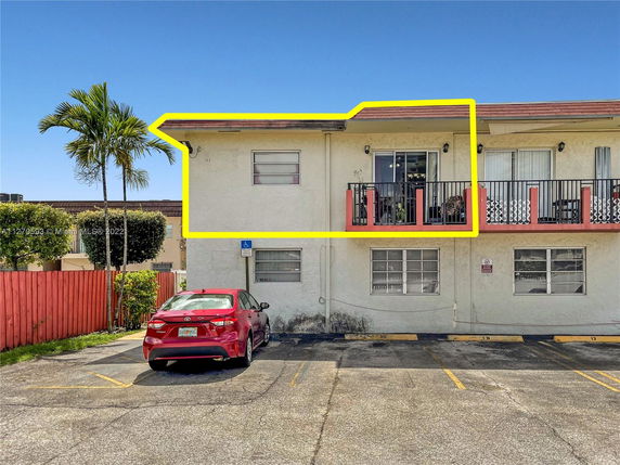 Front view of a two-story building with balconies.