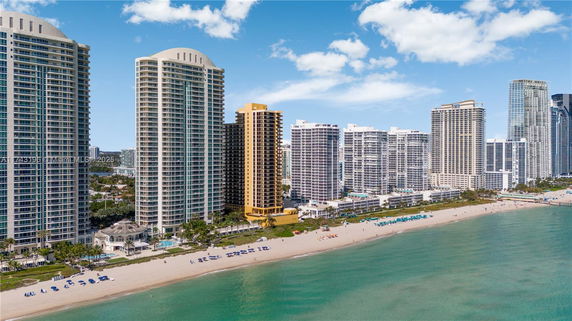 Aerial view of beachfront skyscrapers and coastline.