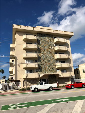 Front view of a multi-story building with a decorative stone facade.