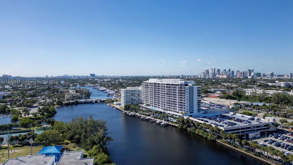 Panoramic view of a high-rise building and surrounding cityscape with a river.