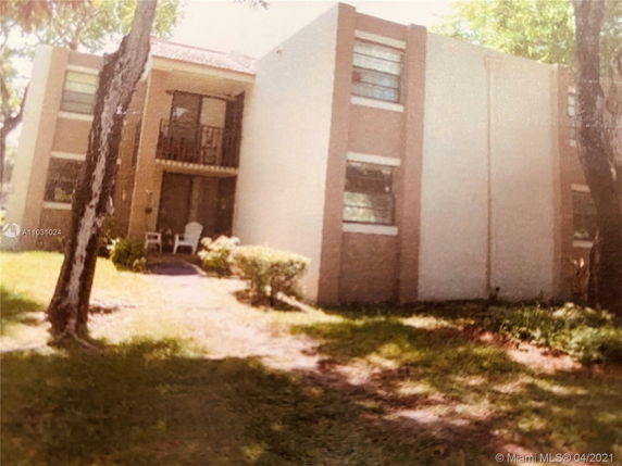 Front view of a two-story building with a small porch area.