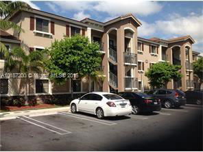 Front view of a multi-story residential building with balconies and arches.