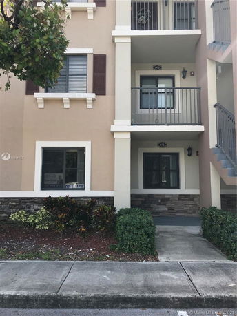 Front view of a multi-story residential building with balconies.