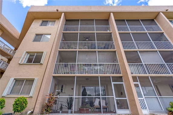 Front view of a multi-story building with screened balconies.