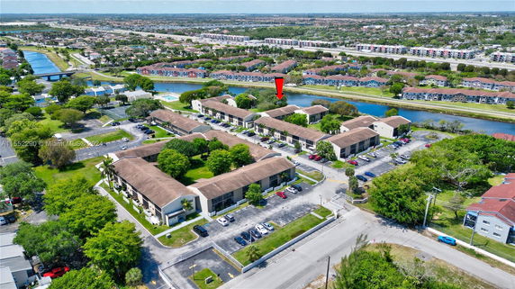 Aerial view of a residential area with multiple apartment buildings and surrounding landscape.