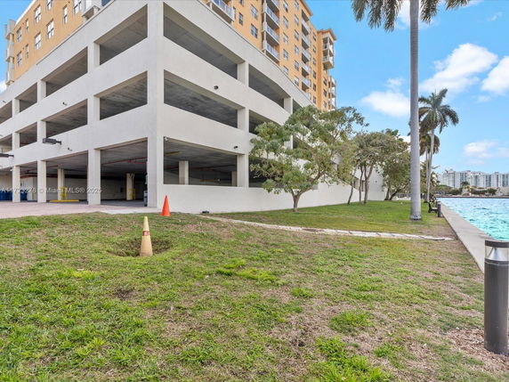 View of a multi-level parking structure adjacent to a waterfront.