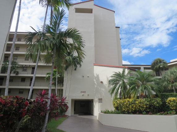 Front view of a multi-story residential building with balconies.