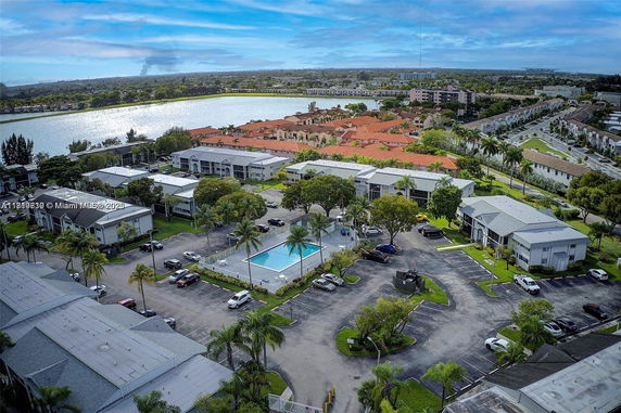 Panoramic view of a residential area with a swimming pool and surrounding buildings.