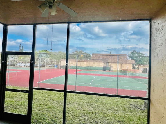 View of tennis court from inside a building