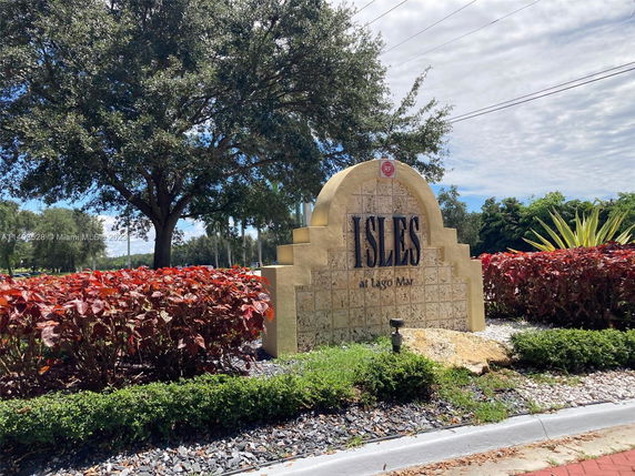 Entry sign for Isles at Lago Mar surrounded by landscaping.