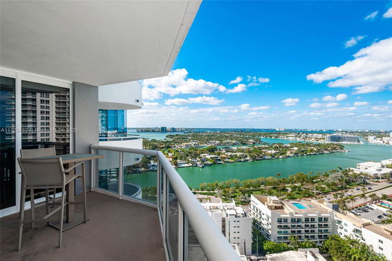 Balcony view overlooking a body of water and cityscape in the distance