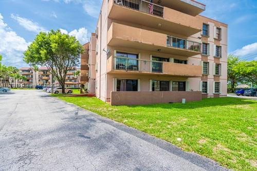 Front view of a multi-story apartment building with balconies.