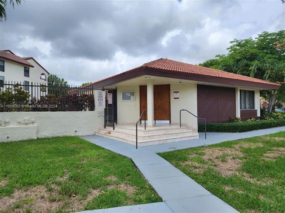 Front view of a small single-story building with a tiled roof.