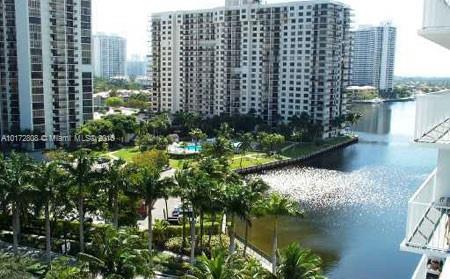View of tall apartment buildings alongside a waterway.