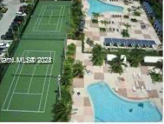 Outdoor area with tennis courts and swimming pools.