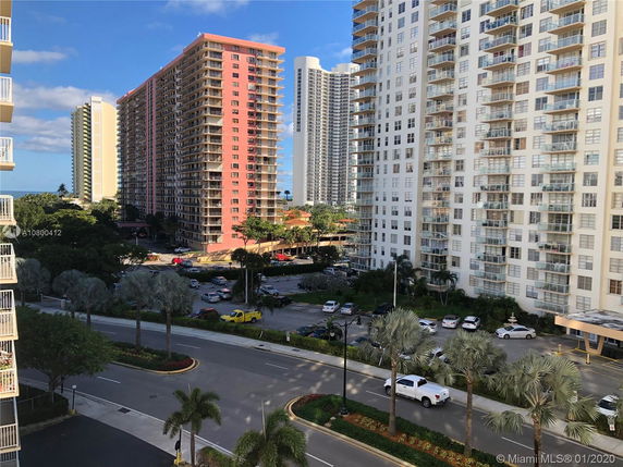 View of multiple residential high-rise buildings with balconies in a city.