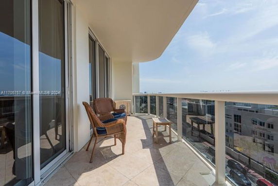 Balcony view from a high-rise building with glass railing.