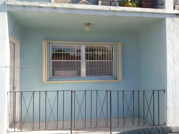 Front view of a building with a window and a small balcony area.