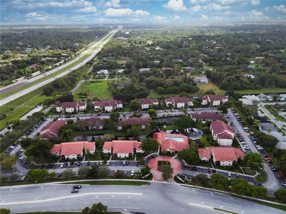 Aerial view of residential community with several buildings and roadways.