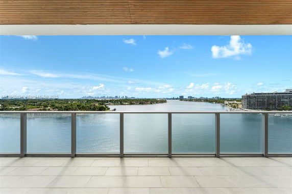 Wide angle view of surrounding water body and cityscape from a balcony.